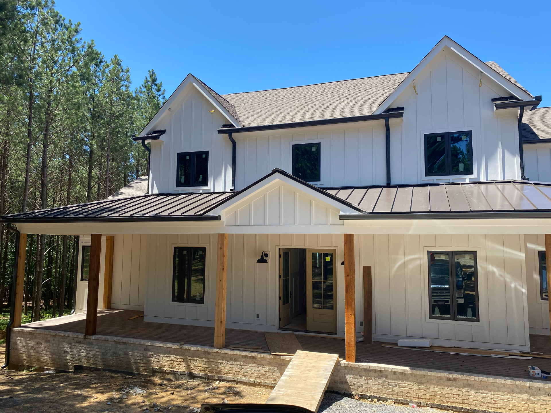 Modern farmhouse style home with black gutters and board and batten siding